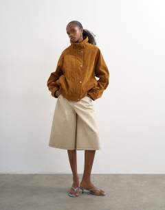 Model wearing Faux suede funnel neck bomber jacket in tan