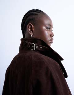 Model wearing Faux suede long car coat with neck tab in brown