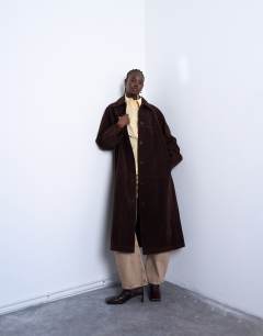Model wearing Faux suede long car coat with neck tab in brown