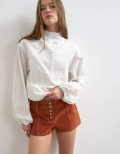 Model wearing Faux suede micro short in rust