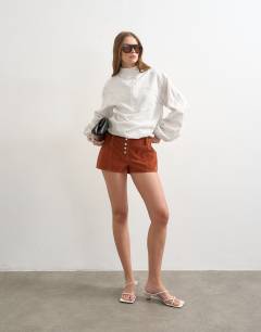 Model wearing Faux suede micro short in rust