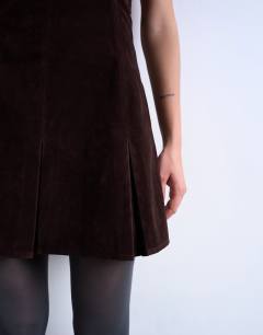 Model wearing Faux suede mini bandeau with pleated hem in chocolate