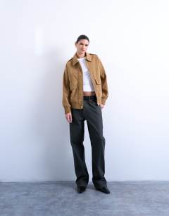 Model wearing Faux suede oversized bomber in tan