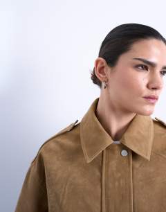 Model wearing Faux suede oversized bomber in tan