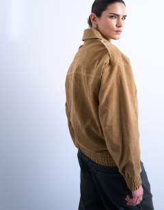 Model wearing Faux suede oversized bomber in tan
