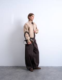 Model wearing Faux suede ovoid sleeve bomber jacket in stone