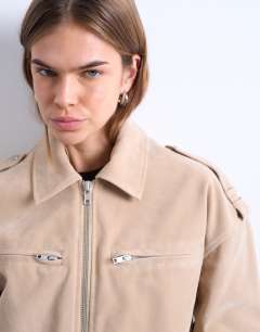 Model wearing Faux suede ovoid sleeve bomber jacket in stone