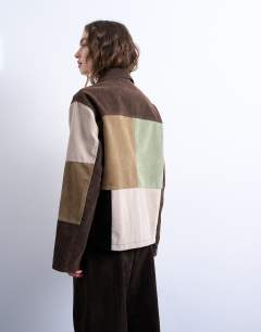 Model wearing Faux suede patchwork bomber jacket in multi