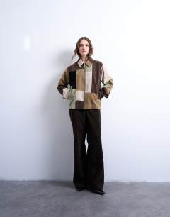 Model wearing Faux suede patchwork bomber jacket in multi
