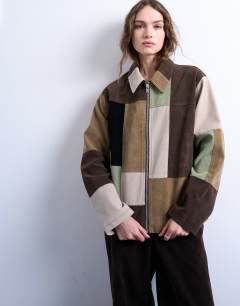 Model wearing Faux suede patchwork bomber jacket in multi