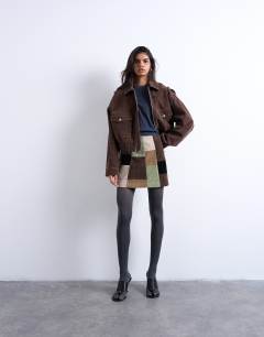 Model wearing Faux suede patchwork mini skirt in multi