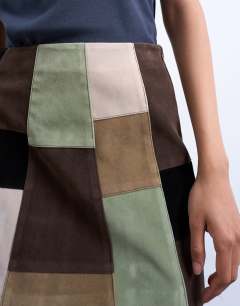 Model wearing Faux suede patchwork mini skirt in multi