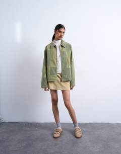 Model wearing Faux suede patchwork zip through jacket in green