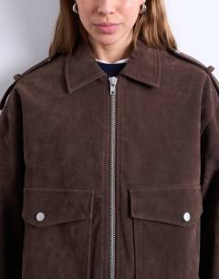 Model wearing Faux suede quilted lined bomber jacket with popper details in chocolate