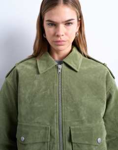 Model wearing Faux suede quilted lined bomber jacket with popper details in sage green