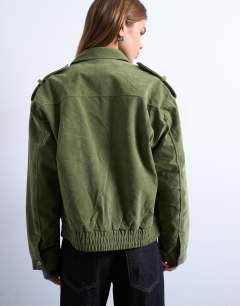 Model wearing Faux suede quilted lined bomber jacket with popper details in sage green