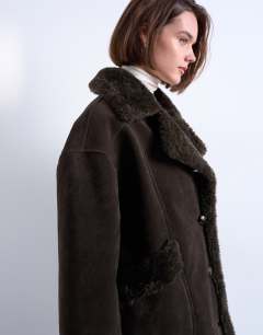Model wearing Faux suede shearling oversized car coat in chocolate