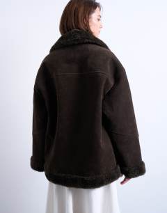 Model wearing Faux suede shearling oversized car coat in chocolate