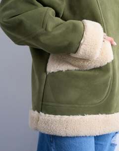 Model wearing Faux suede shearling oversized car coat in olive green