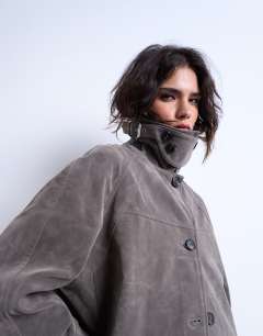 Model wearing Faux suede short funnel neck car coat with neck tab in grey