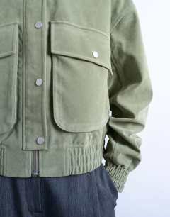 Model wearing Faux suede short jacket with patch pockets in sage