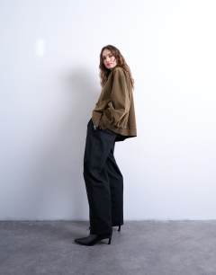 Model wearing Faux suede super oversized quilted lined bomber jacket with patch pockets in tan