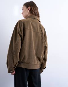 Model wearing Faux suede super oversized quilted lined bomber jacket with patch pockets in tan