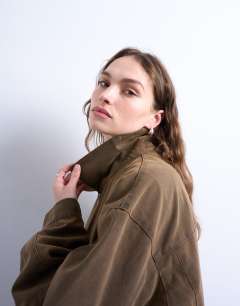 Model wearing Faux suede super oversized quilted lined bomber jacket with patch pockets in tan