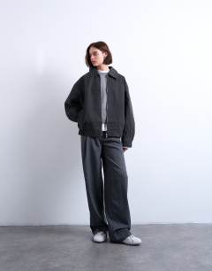 Model wearing Faux suede super oversized quilted lined bomber jacket with patch pockets in washed black