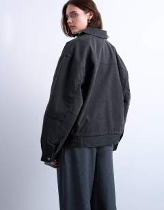 Model wearing Faux suede super oversized quilted lined bomber jacket with patch pockets in washed black