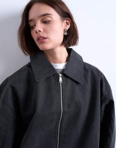 Model wearing Faux suede super oversized quilted lined bomber jacket with patch pockets in washed black