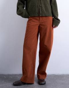 Model wearing Faux suede wide leg trouser with seam detail in rust