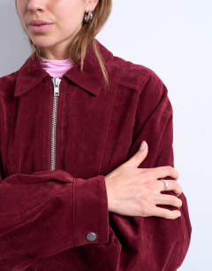 Model wearing Faux suede zip through seam detail jacket in burgundy