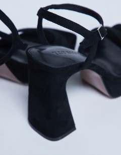 Model wearing Faye chunky platform heeled sandal in black 