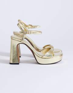 Model wearing Faye platform two part high heel sandal in gold