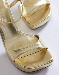 Model wearing Faye platform two part sandal in gold