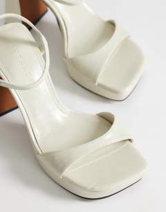 Model wearing Faye platform two part sandal in off white