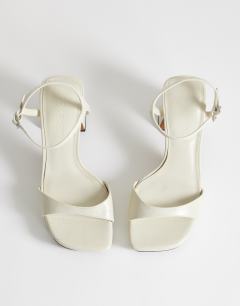 Model wearing Faye platform two part sandal in off white
