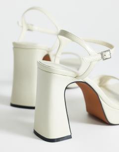 Model wearing Faye platform two part sandal in off white