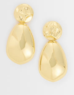 Model wearing Faye stud drop earrings in gold