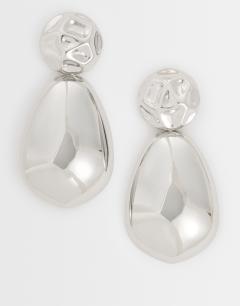 Model wearing Faye stud drop earrings in silver