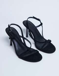 Model wearing Felicity strappy high heeled sandal in black faux suede 