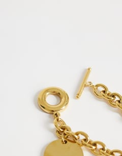 Model wearing Felix waterproof charm bracelet in stainless gold