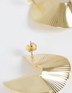 Model wearing Fergy folded detail earring in gold