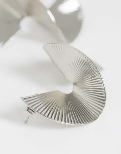 Model wearing Fergy folded detail earring in silver