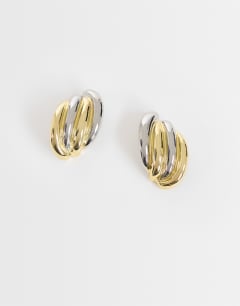 Model wearing Fia statement stud earrings in silver and gold