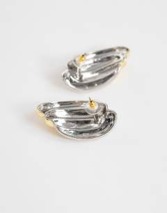 Model wearing Fia statement stud earrings in silver and gold