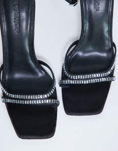 Model wearing Fifi embellished flare heel sandal in black