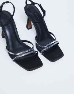 Model wearing Fifi embellished flare heel sandal in black