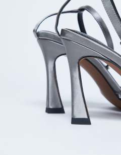 Model wearing Fifi embellished flare heel sandal in silver 